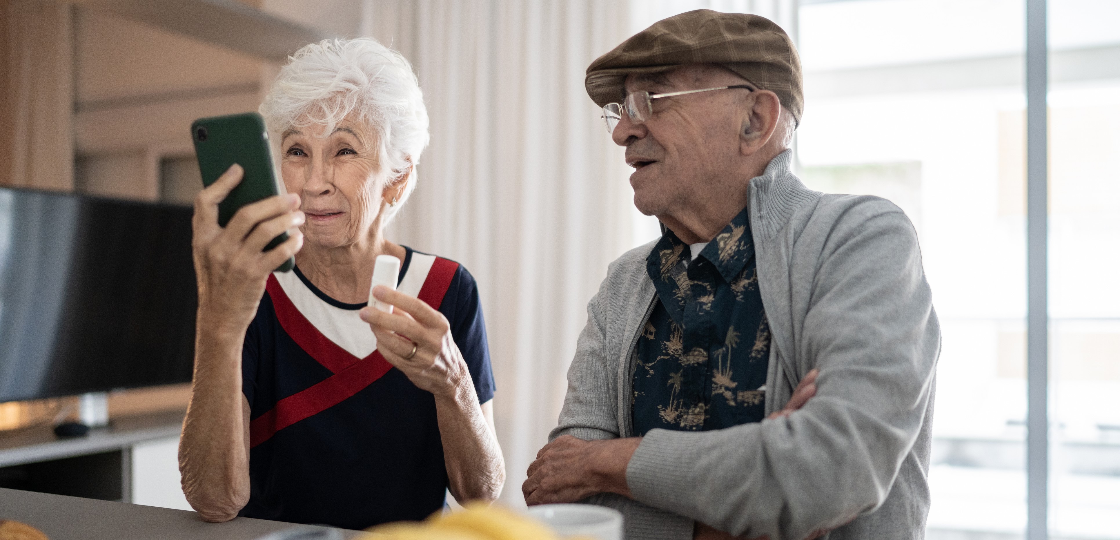 Seniors using telehealth services on a tablet for a remote doctor's appointment.